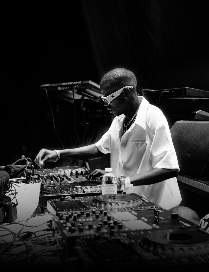 A DJ at the decks, in black and white